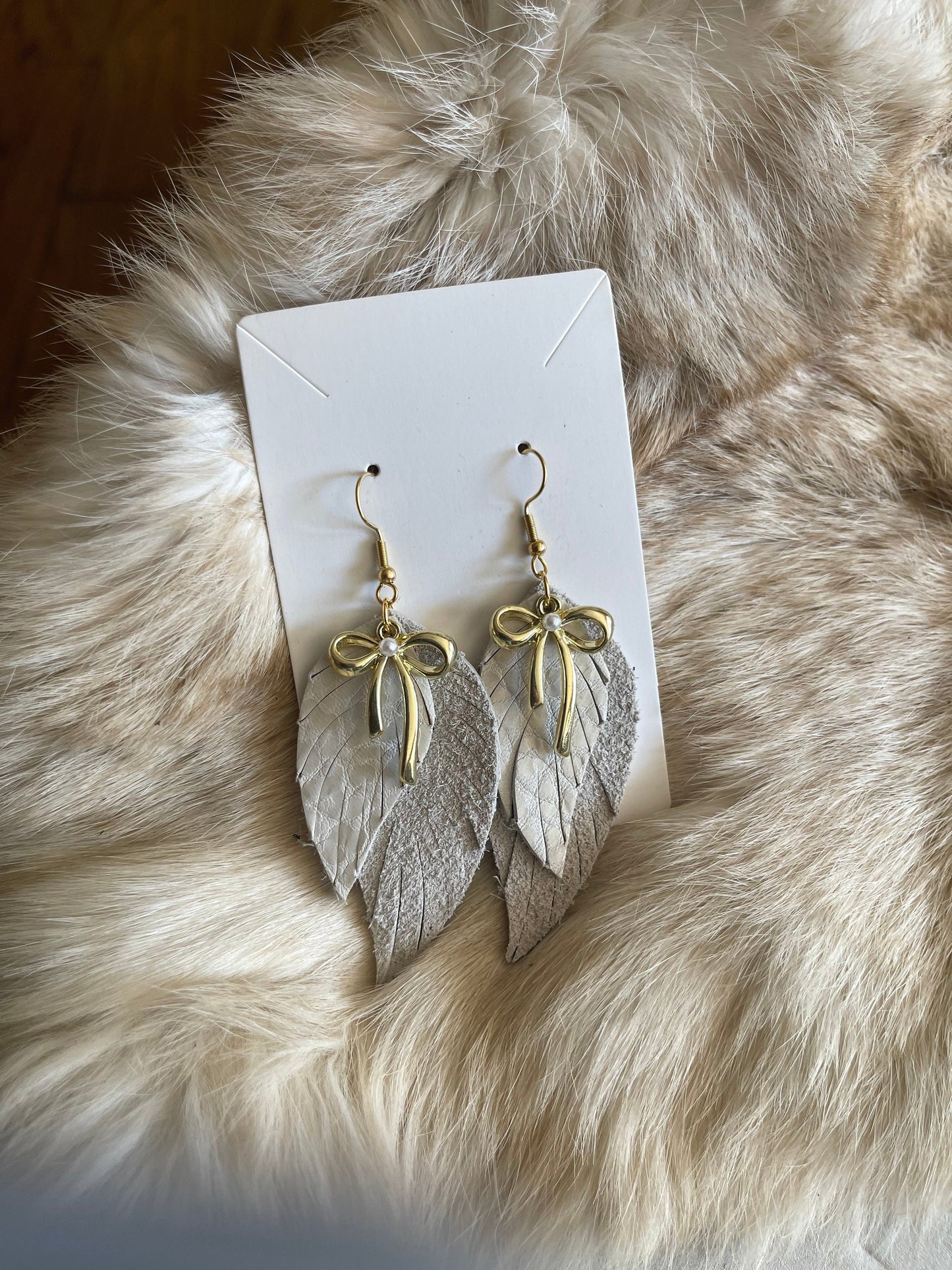 Angelic Bows Fringed Leather Earrings - Boho Glam with Golden Bow Accenet