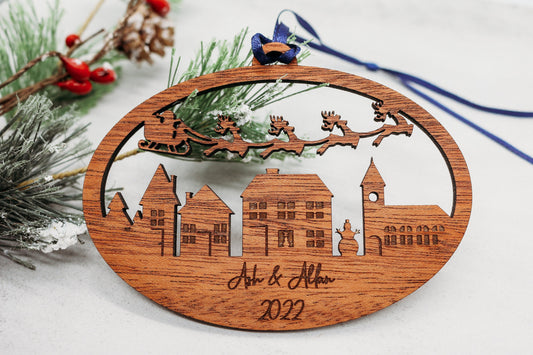 Engraved Wooden Christmas Ornament: Santa's Sleigh Flying Over Charming Village Personalized